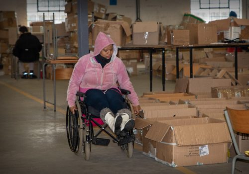 Lady packing boxes in wheelchair